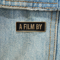A Film by Credit Enamel Pin